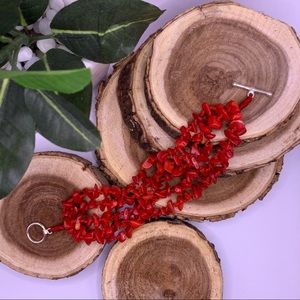 Multi-strand bright red simulated coral chips with sterling silver clasp.